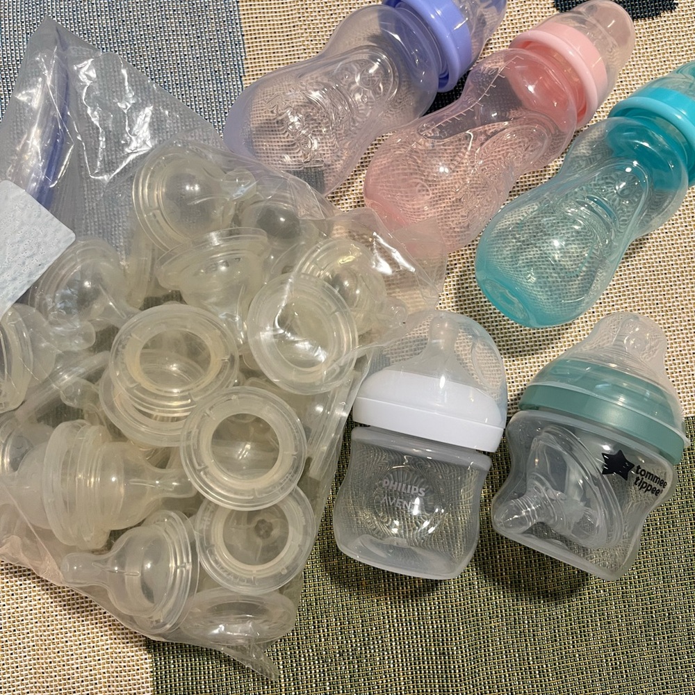 Assortment of baby bottles & nipples